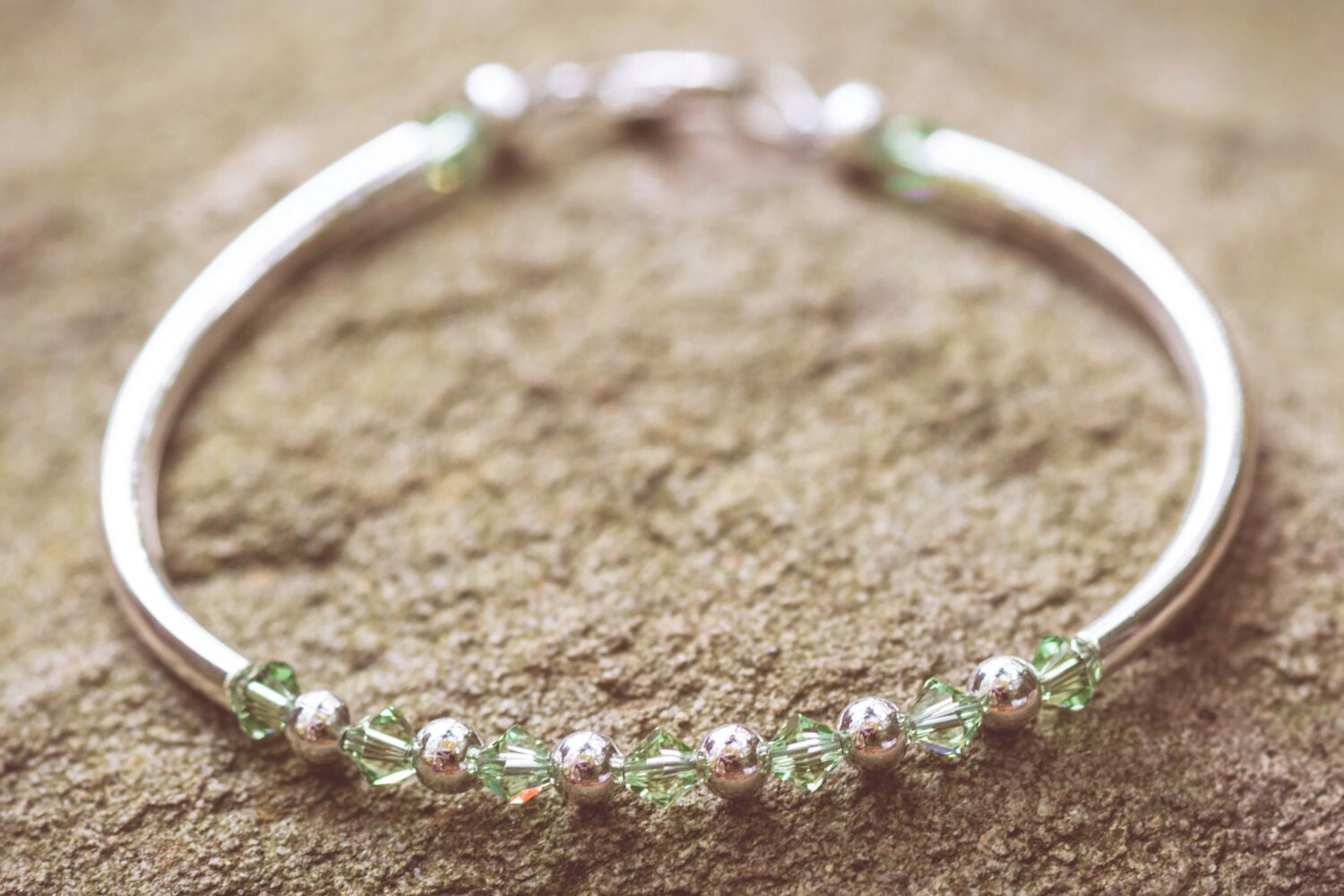August Peridot Swarovski Crystal Birth Month Sterling Silver Plated Bracelet on stone