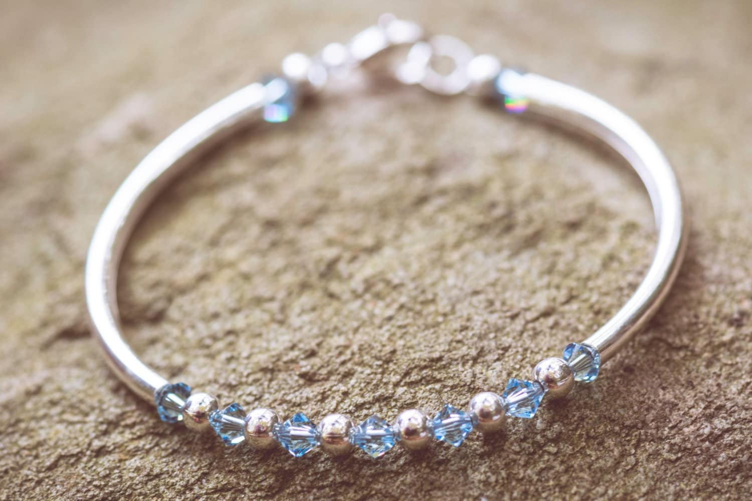 March Aquamarine Swarovski Crystal Birth Month Sterling Silver Plated Bracelet on stone