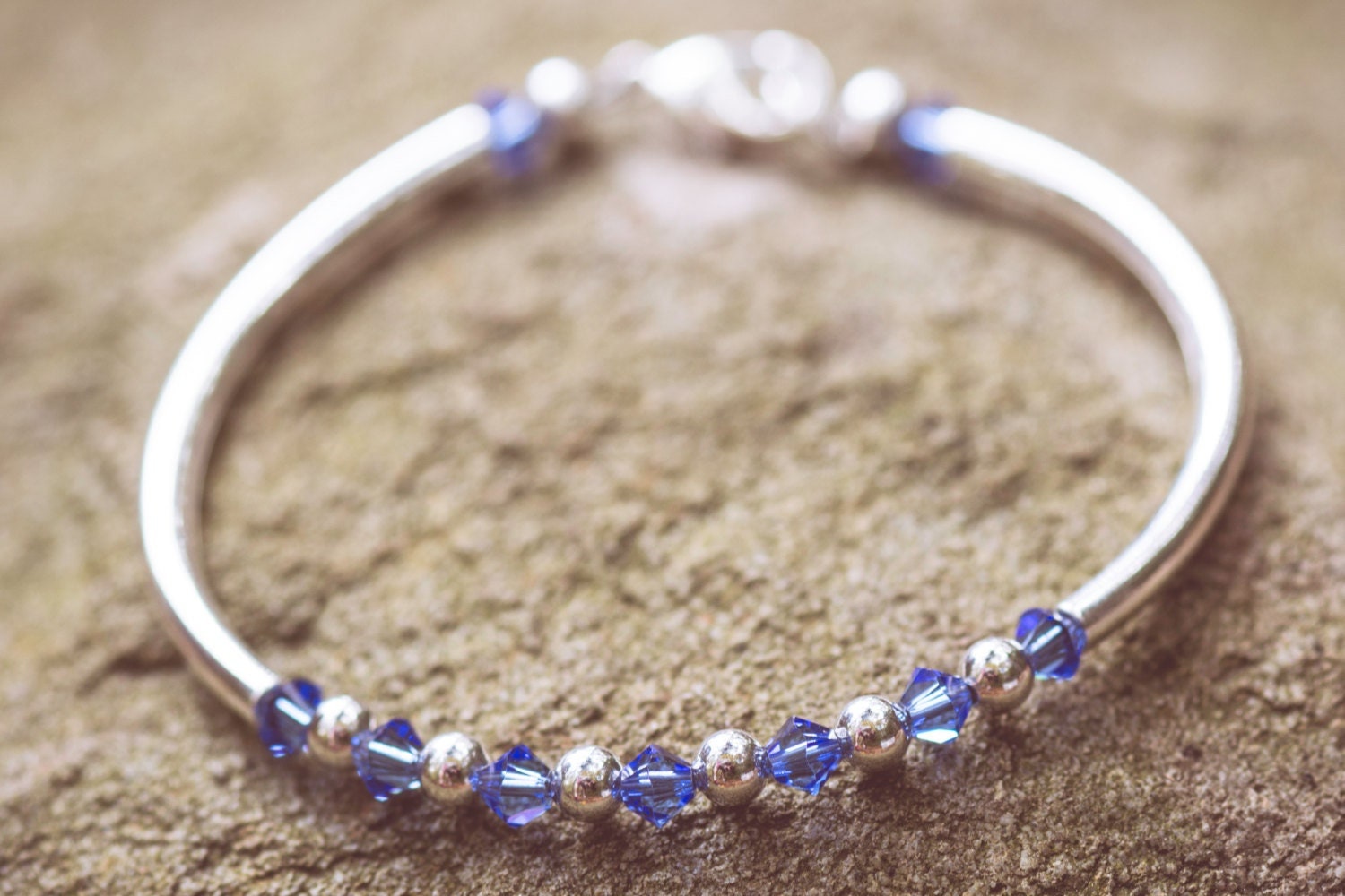 September Sapphire Swarovski Crystal Birth Month Sterling Silver Plated Bracelet on stone