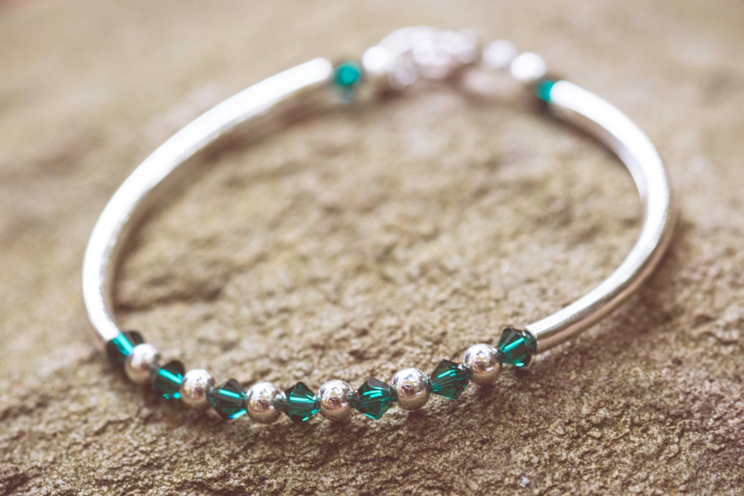 May Emerald Swarovski Crystal Birth Month Sterling Silver Plated Bracelet on stone