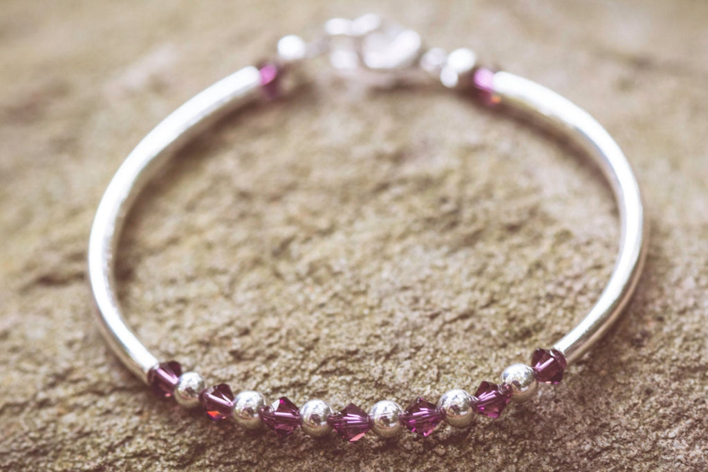 February Amethyst Swarovski Crystal Birth Month Sterling Silver Plated Bracelet on stone