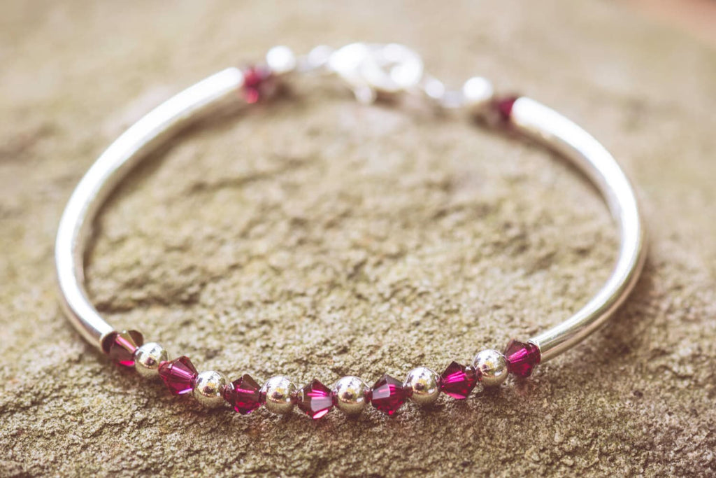 July Ruby Swarovski Crystal Birth Month Sterling Silver Plated Bracelet on stone