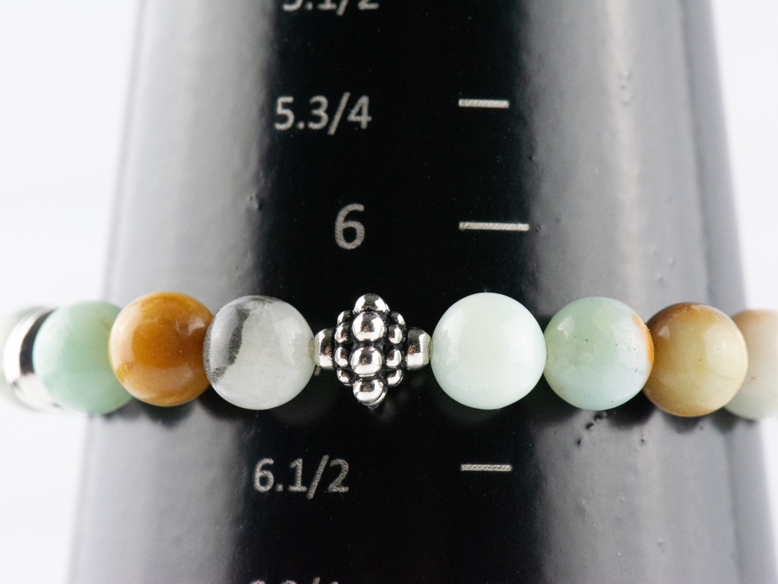 Black Gold Amazonite Genuine Gemstone Stretch Bracelet on a black bracelet mandrel size 6.25 stretch