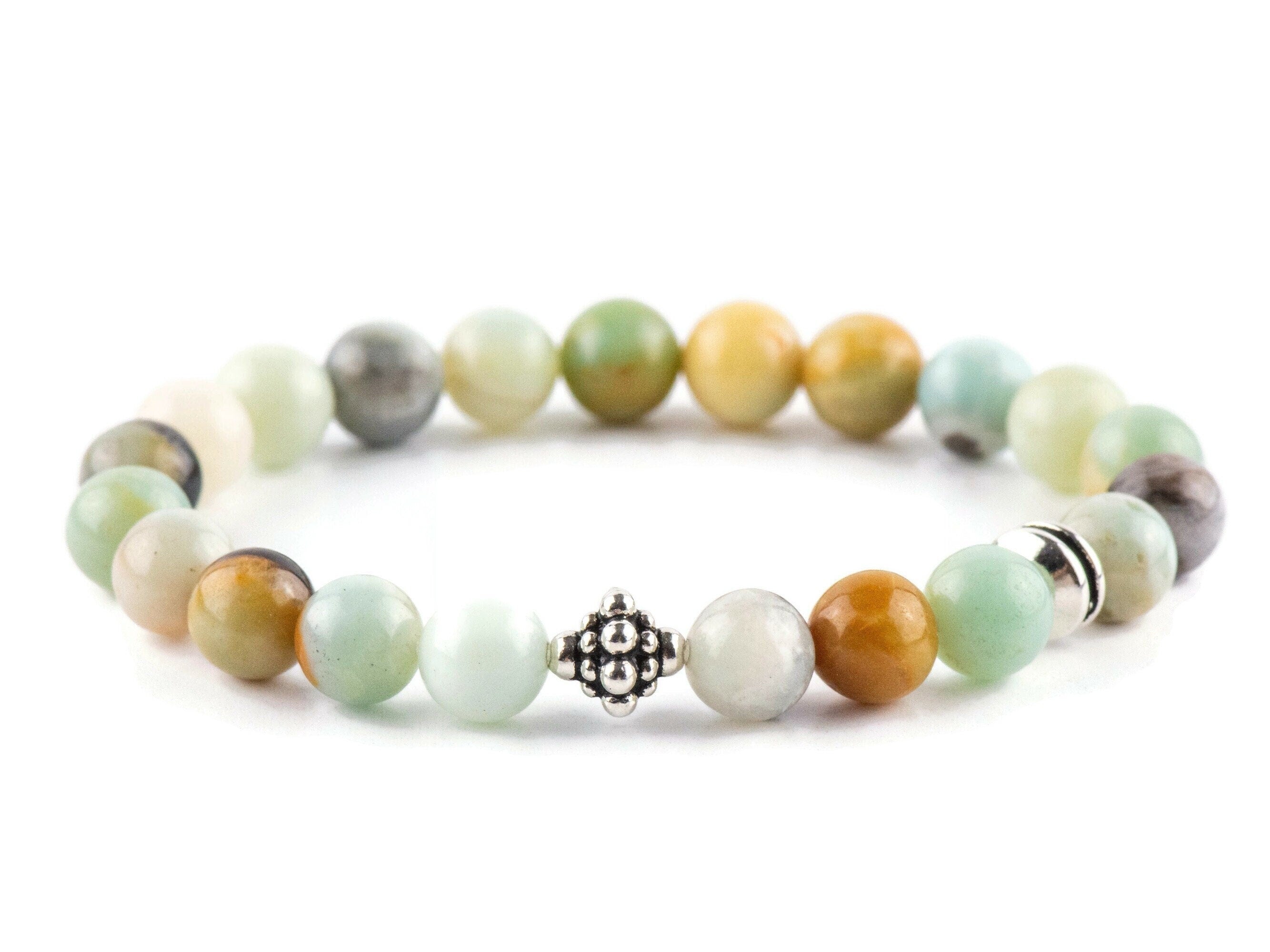 Black Gold Amazonite Genuine Gemstone Stretch Bracelet on white background. Amazonite beads are multicolor earth-tones. Center bead is a silver Bali style bead.