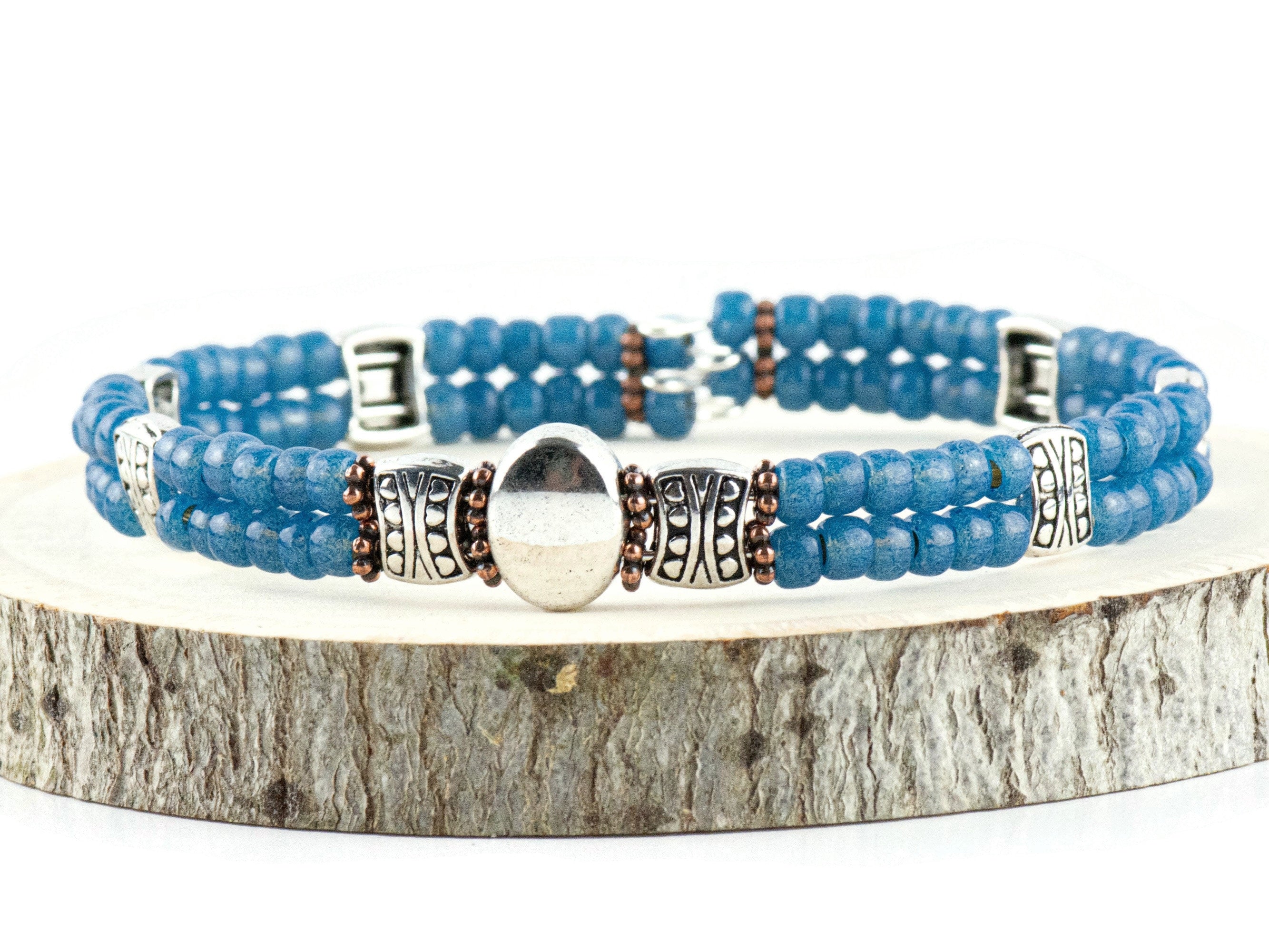 Button and Bows French Blue Cuff Memory Wire Bracelet on a wood piece with tree bark edging