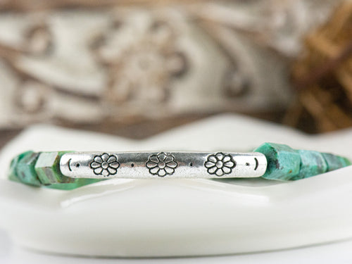 African Turquoise Stretch Bracelet close up of silver pewter tube focal bead adorned with floral etchings