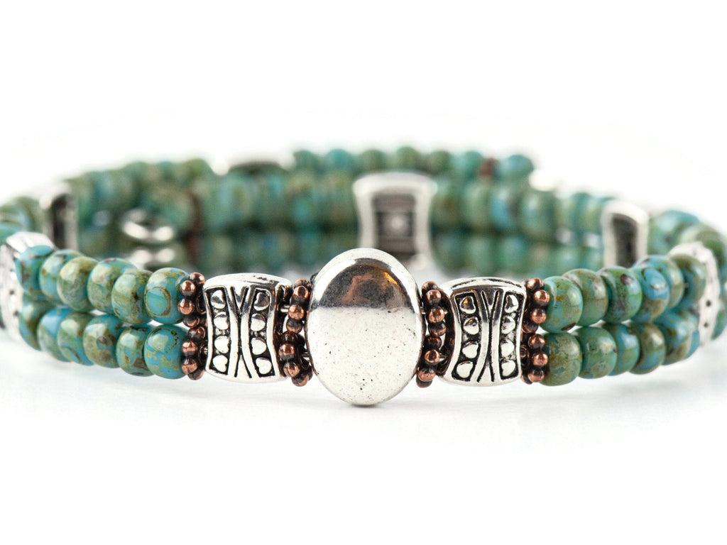 Button and Bows Desert Turquoise Cuff Memory Wire Bracelet on white background.