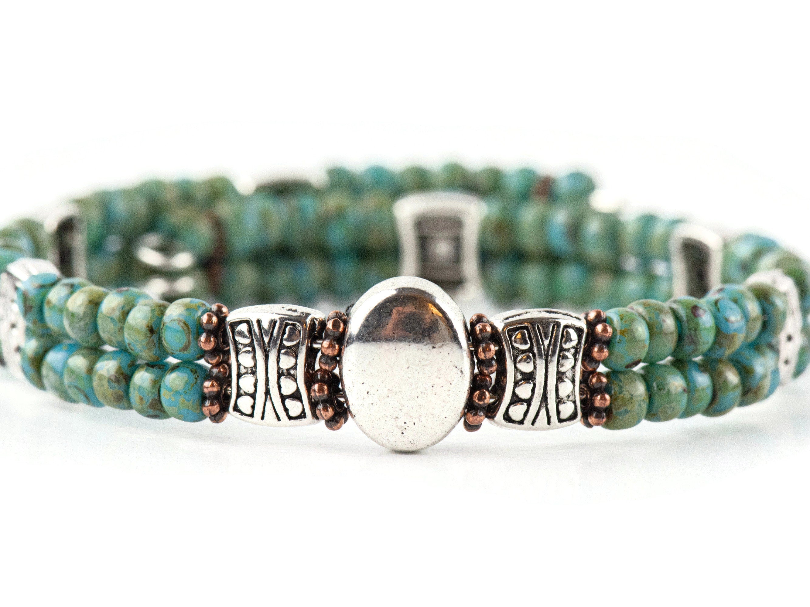 Button and Bows Desert Turquoise Cuff Memory Wire Bracelet on white background.