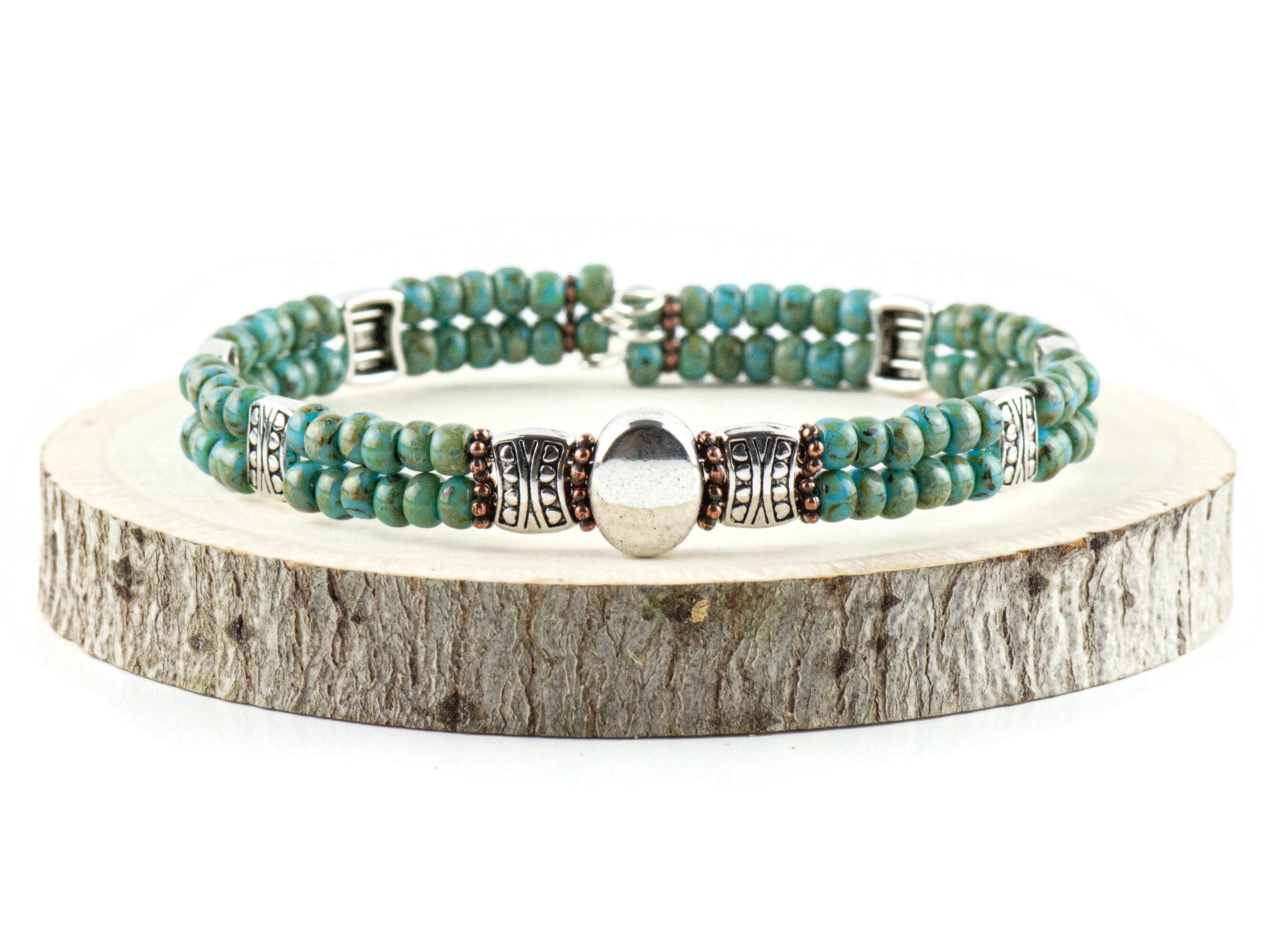Button and Bows Desert Turquoise Cuff Memory Wire Bracelet on a wood piece with tree bark edging
