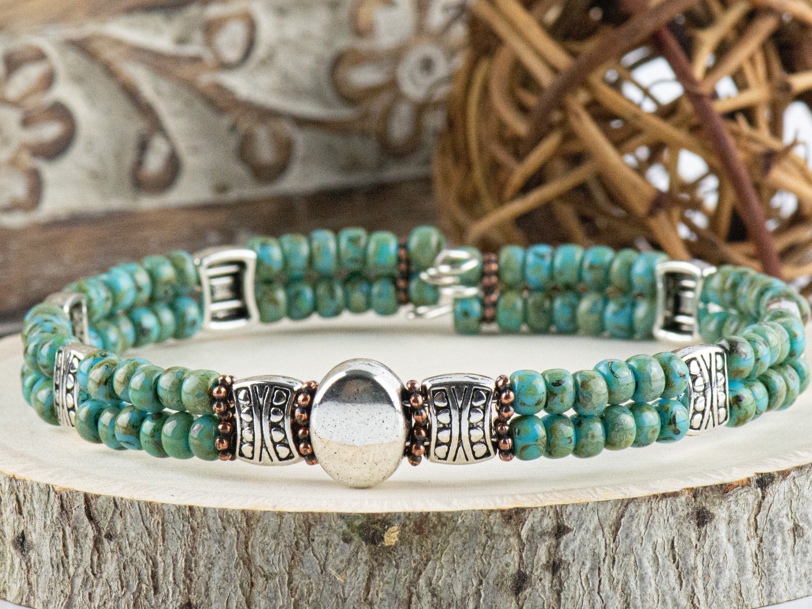 Button and Bows Desert Turquoise Cuff Memory Wire Bracelet close up on a wood piece with tree bark edging