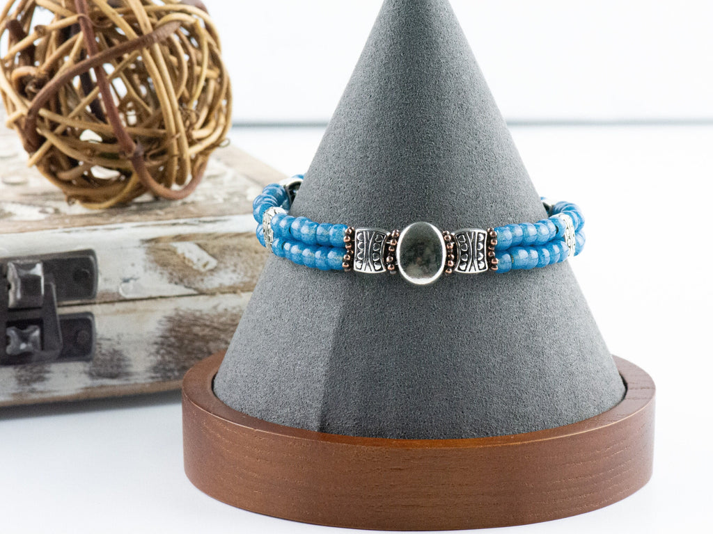 Button and Bows French Blue Cuff Memory Wire Bracelet on a decorative black bracelet stand.