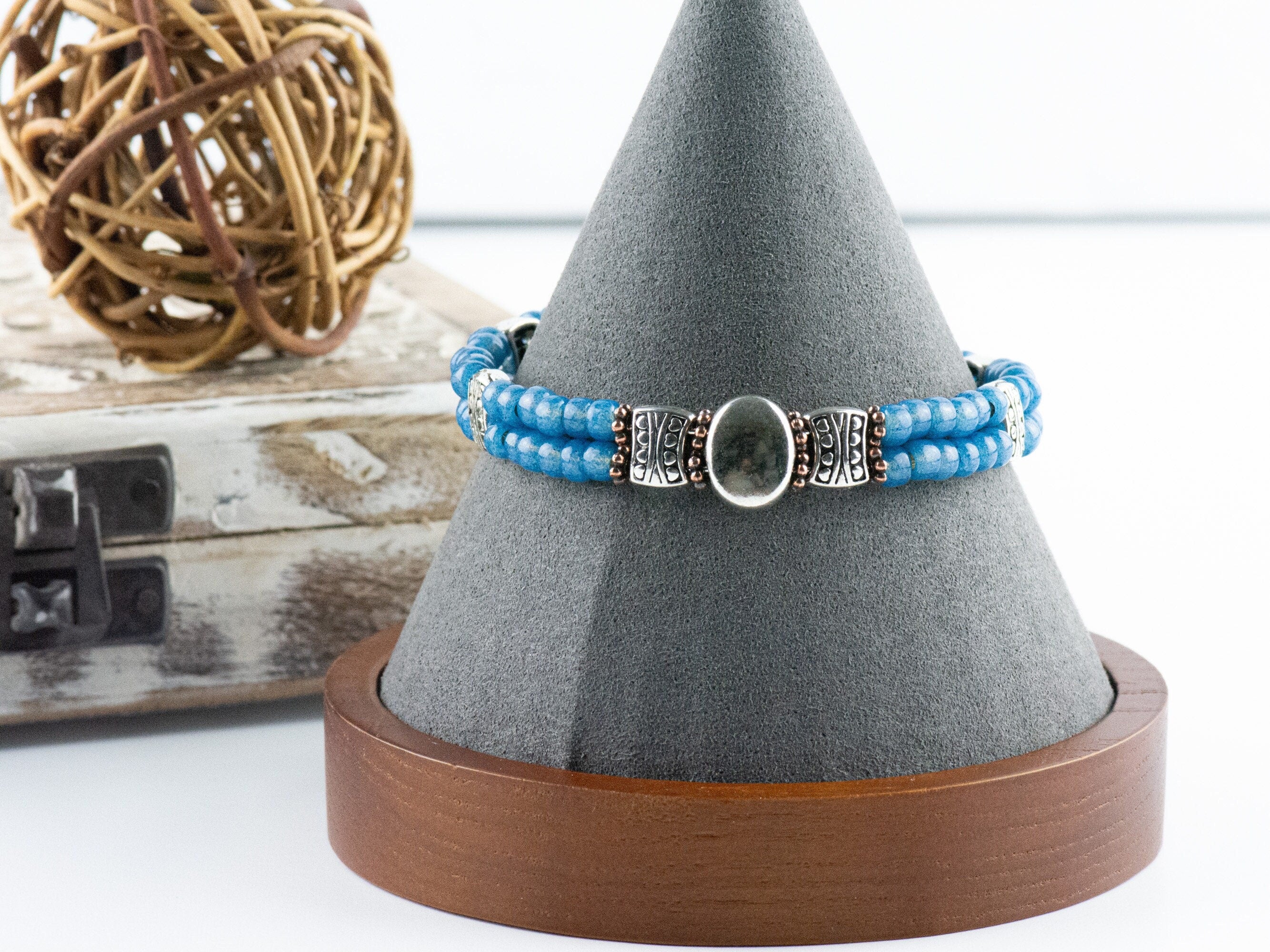 Button and Bows French Blue Cuff Memory Wire Bracelet on a decorative black bracelet stand.