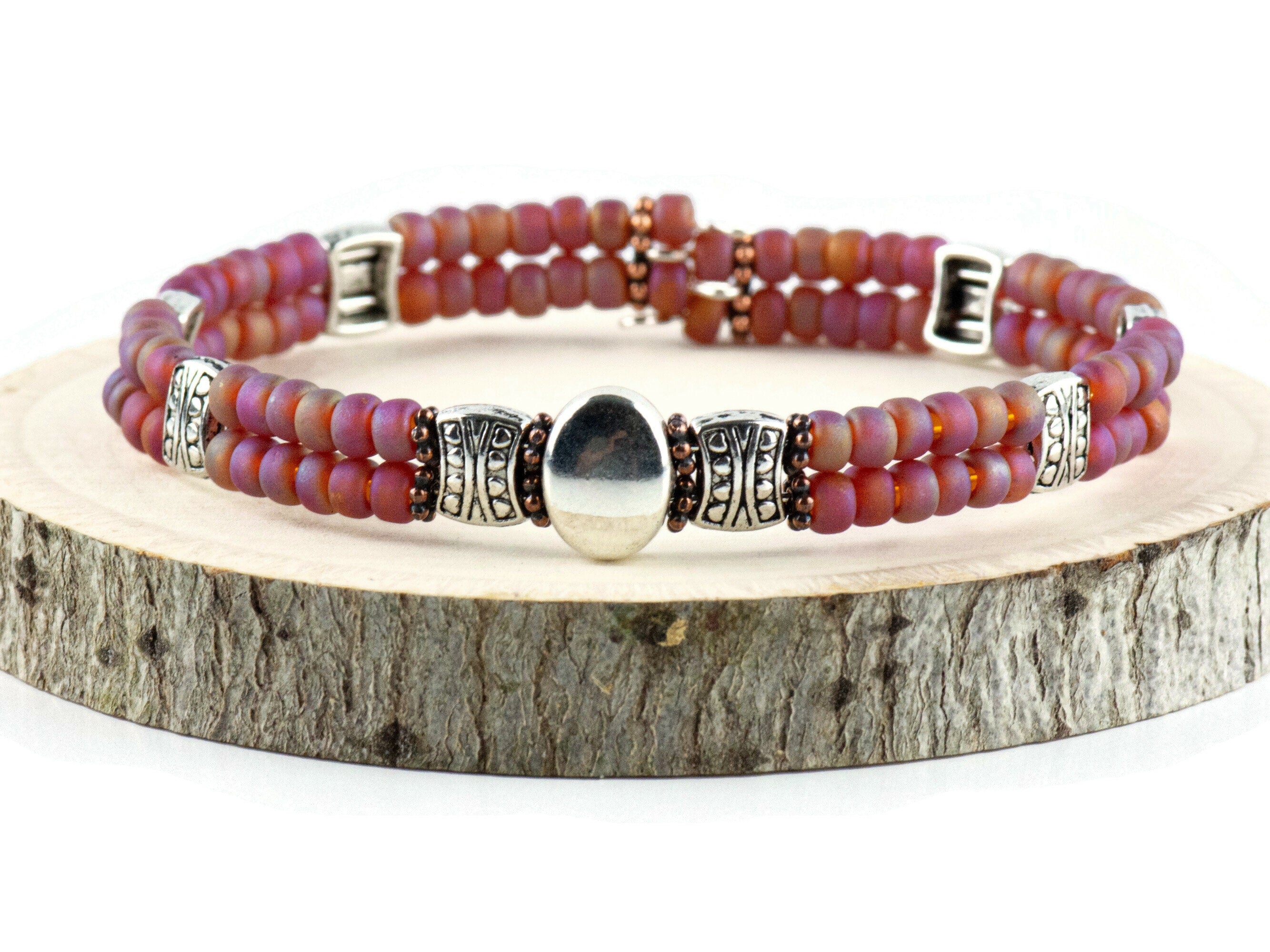 Button and Bows Raspberry Sorbet Cuff Memory Wire Bracelet on a wood piece with tree bark edging