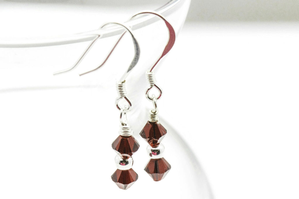 January Garnet Swarovski Crystal Birth Month Sterling Silver Drop Earrings hanging on vase