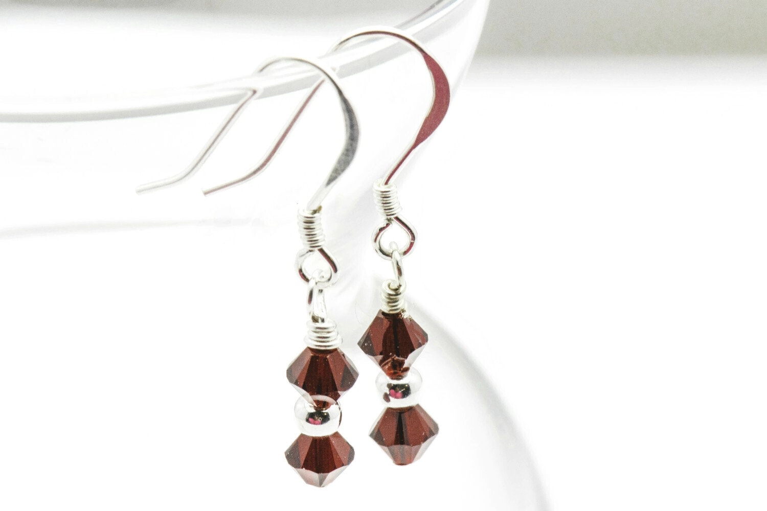 January Garnet Swarovski Crystal Birth Month Sterling Silver Drop Earrings hanging on vase