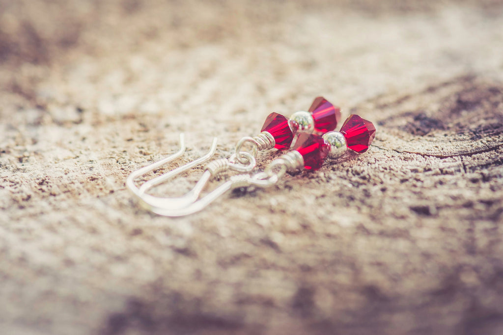 January Garnet Swarovski Crystal Birth Month Sterling Silver Drop Earrings on wood background