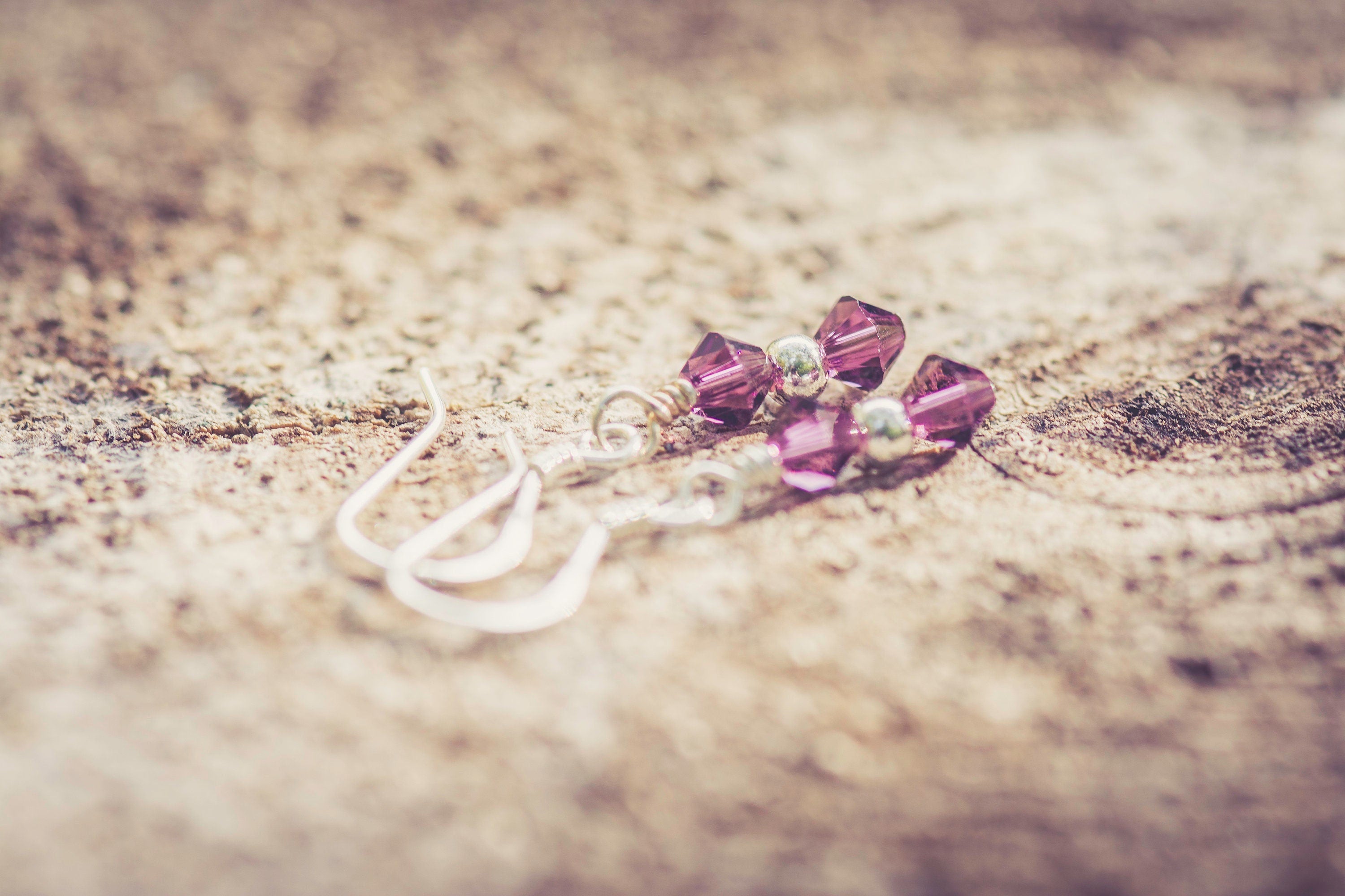 February Amethyst Swarovski Crystal Birth Month Sterling Silver Drop Earrings on wood background