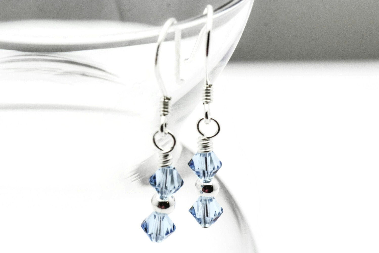 March Aquamarine Swarovski Crystal Birth Month Sterling Silver Drop Earrings hanging on vase
