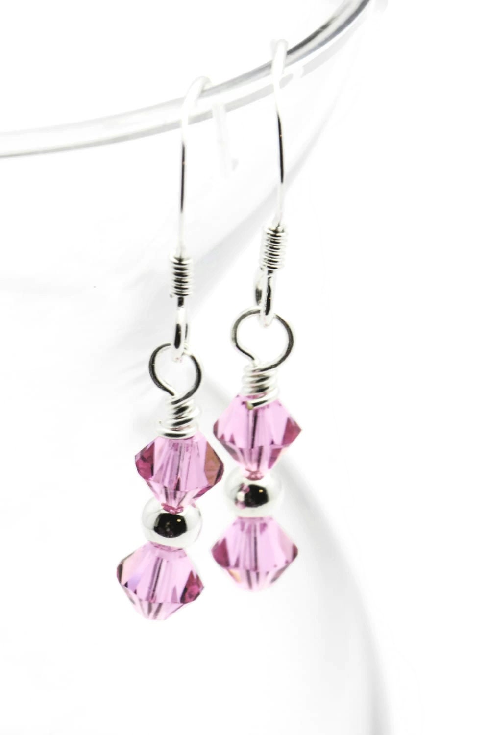 October Rose Swarovski Crystal Birth Month Sterling Silver Drop Earrings hanging on vase