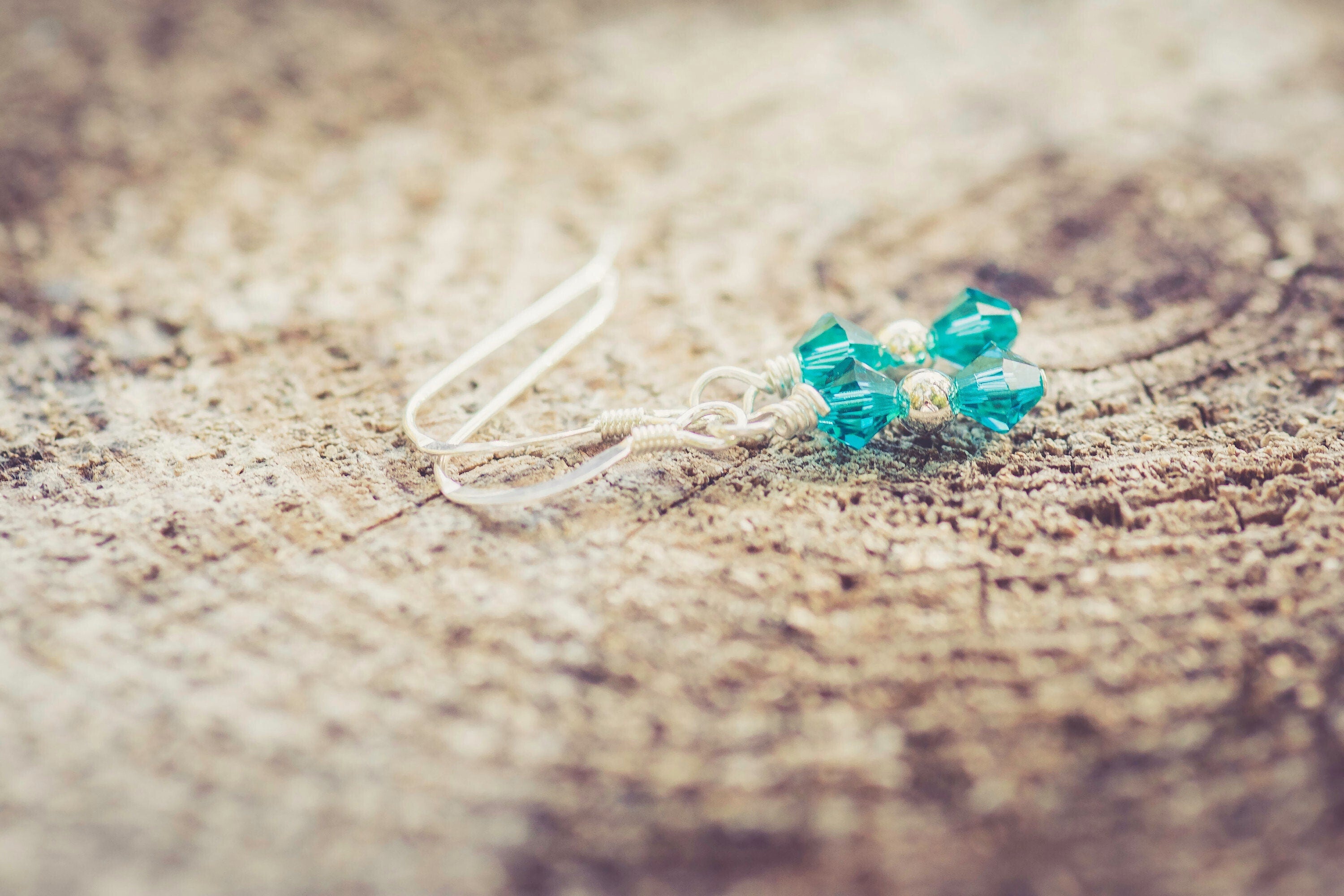 December Blue Zircon Swarovski Crystal Birth Month Sterling Silver Drop Earrings on wood background