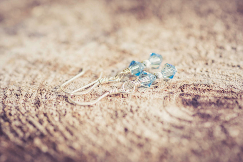 March Aquamarine Swarovski Crystal Birth Month Sterling Silver Drop Earrings on wood background