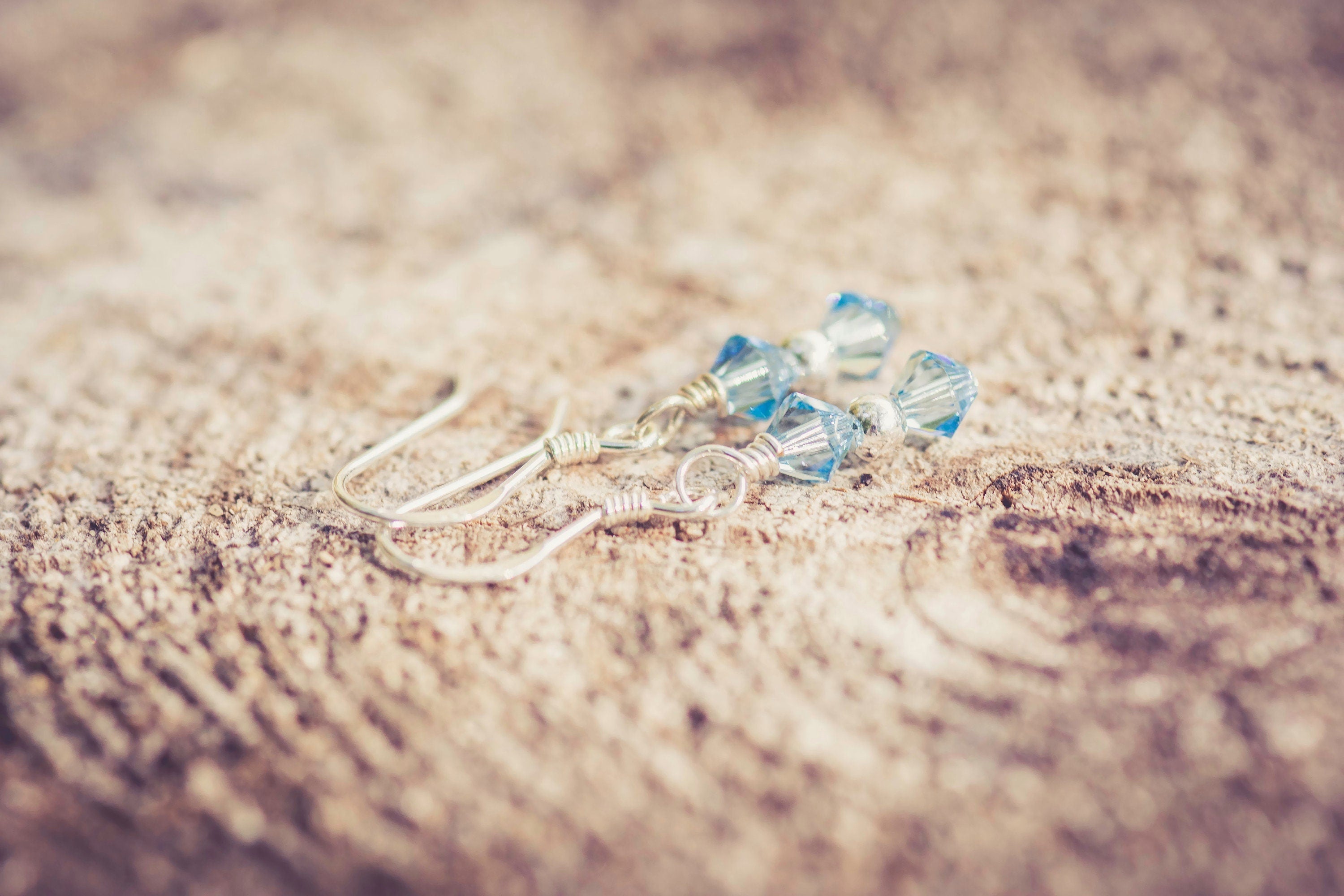 March Aquamarine Swarovski Crystal Birth Month Sterling Silver Drop Earrings on wood background