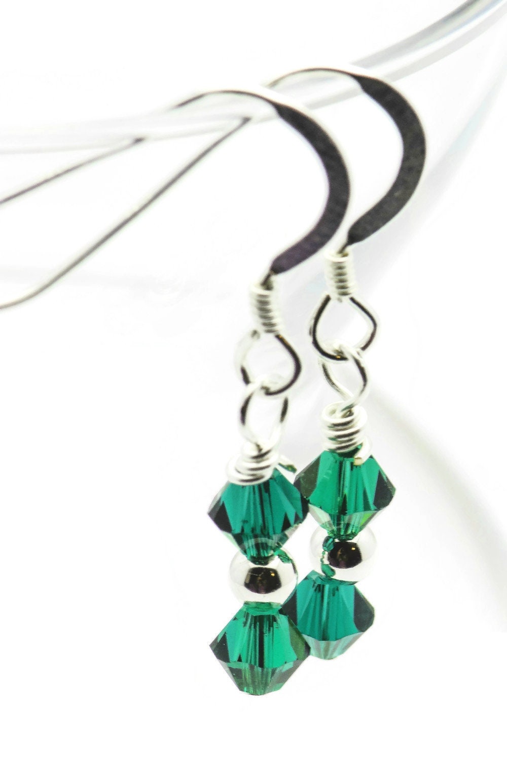 May Emerald Swarovski Crystal Birth Month Sterling Silver Drop Earrings hanging on vase