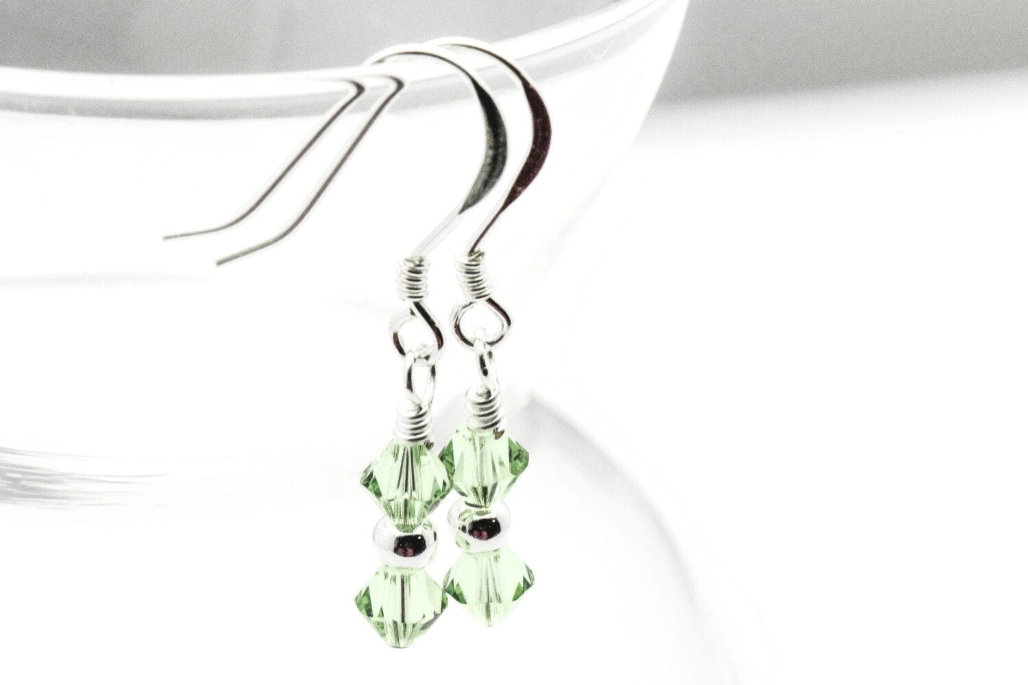 August Peridot Swarovski Crystal Birth Month Sterling Silver Drop Earrings hanging on vase