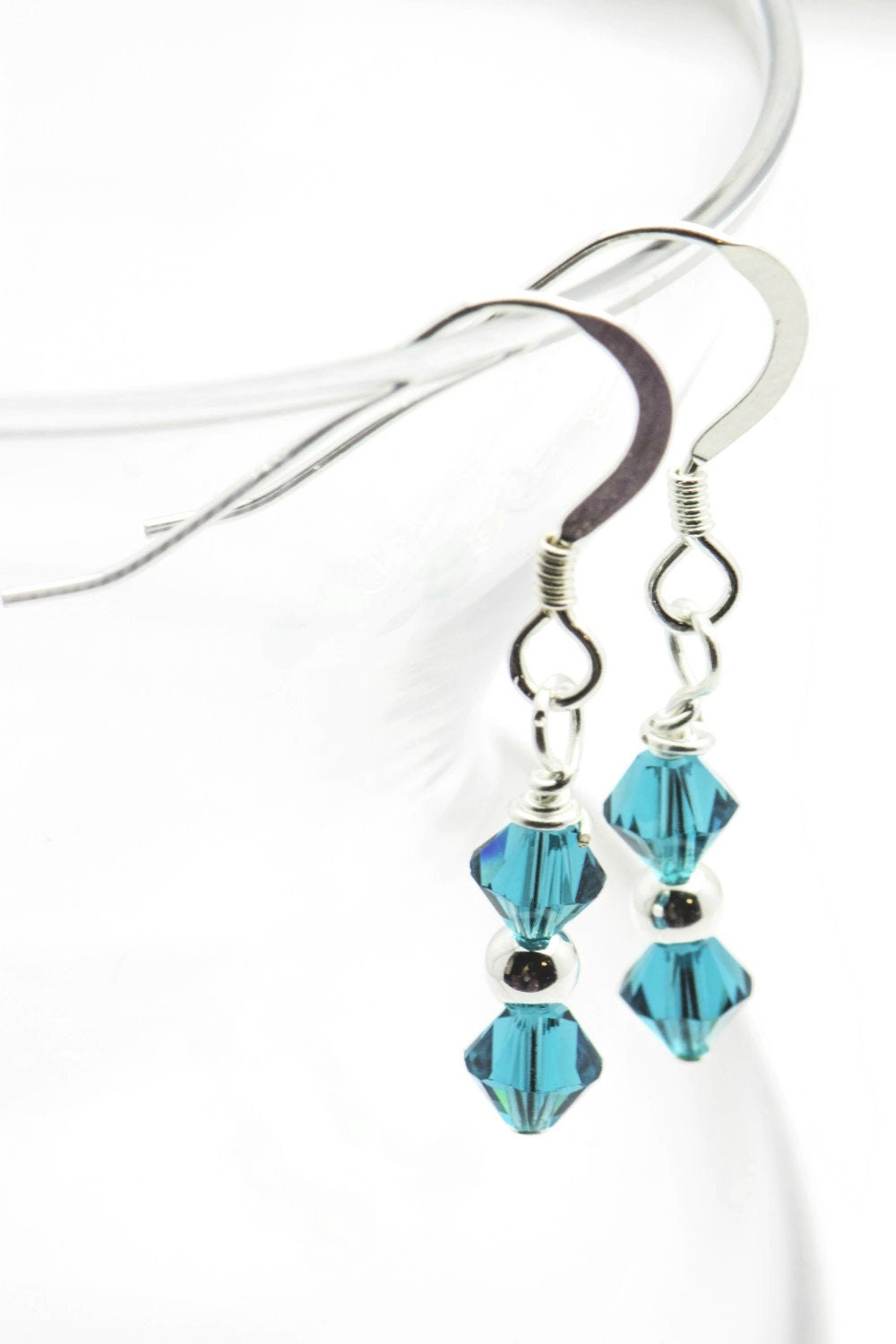 December Blue Zircon Swarovski Crystal Birth Month Sterling Silver Drop Earrings hanging on vase